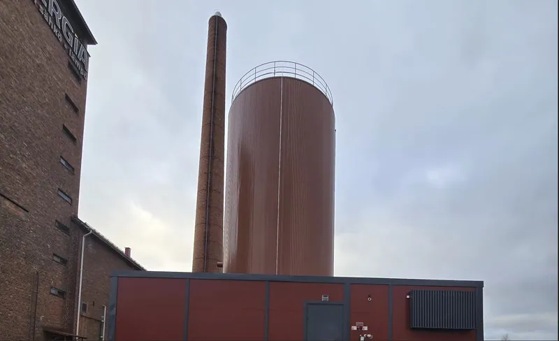 Lämpövarasto ja sähkökattilakontti Keuruun lämpövoimalan tiilipiipun vieressä